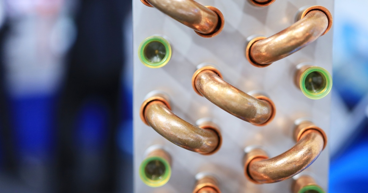 A close-up of copper U-bend tubes and coils assembled into heat and evaporator exchangers for a machine.